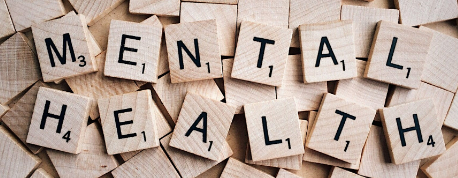 Wooden blocks spelling 'mental health' in capita letters.