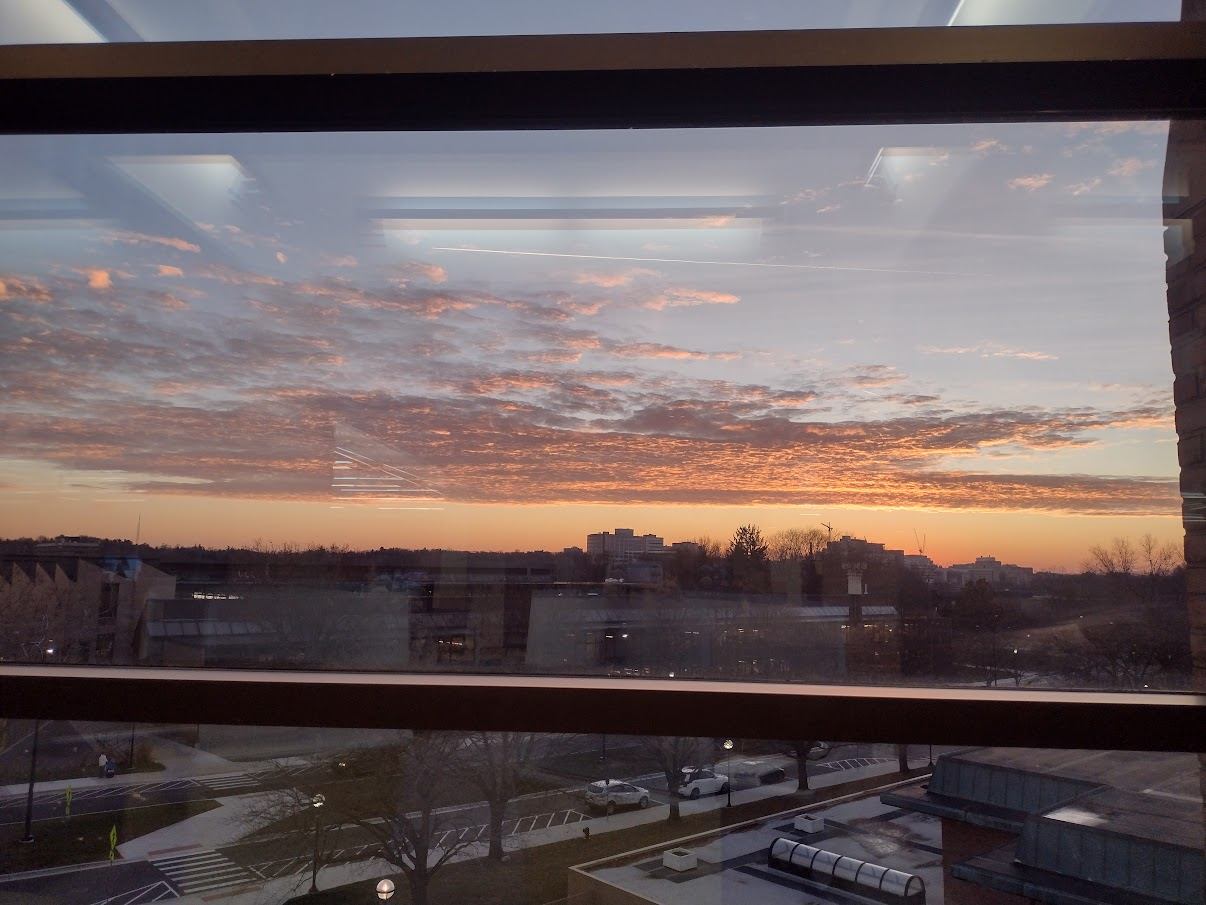 Image description: Sunset out the window of the Duderstadt Center Library on the third floor